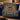 Hanukkah Twin Lions Menorah woven blanket draped over a navy velvet sofa