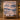 Harbor Regatta Lighthouse quilt hung on a wall above a bench with 2 matching pillowcases