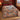Hawk Migration Ridge Pattern woven blanket spread on a bed with rust and slate hawk scenes
