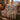 Hawk Migration Ridge Pattern woven blanket draped over a sofa by a fireplace