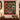 Personalized Heirloom Ornament Christmas photo blanket with nine family photos displayed on a wall above a console