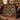 Vintage glass ornament photo collage fleece blanket draped over a green velvet sofa by a fireplace