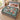 Hellebore Ornament Christmas woven blanket spread across a bed in a Christmas bedroom