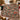 Holly Ribbon Hens Christmas woven blanket draped over a sofa by a Christmas fireplace