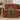 Red gingerbread ornament tree woven blanket draped over a green sofa