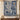 Indigo Hanukkah Lamps Around the World woven blanket displayed as a wall tapestry above a console with a lion menorah