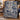 Indigo Hanukkah Lamps Around the World woven blanket draped over a blue armchair