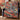 Indigo Vermilion Koi Garden Pattern woven blanket draped over a navy armchair