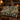 Japanese Anemone Sundial Garden woven blanket draped over a leather sofa by a fireplace