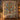 Personalized Jesse Tree Advent Candles quilt with custom family name hung on a wall above a bench with matching pillowcases