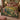 Laburnum Peacock Garden Arch woven blanket spread across a bed like a bedspread