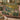 Laburnum Peacock Garden Arch woven blanket draped over a sofa, living room view