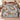 Couple holding a personalized Magnolia Silver Pheasant Reverie woven blanket with custom family name