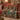 Maple Koi Garden woven blanket draped over a red sofa