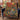Maple Koi Garden woven blanket draped over a navy armchair