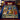 Nativity Stained Glass Window fleece blanket spread on a bed with navy and red pillows