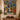 Nativity Stained Glass Window fleece blanket displayed on a wall above a console with candles