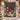 Navy Nutcracker Pomegranate woven blanket displayed on a snowy front porch with Christmas garland and lanterns