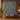 Navy Tulip Songbird Morris Style quilt hung on a wall above a bench with 2 matching pillowcases