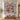 Personalized North Pole Village quilt with custom family name hung on a wall above a bench with matching pillowcases