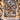 Nutcracker Snowy Courtyard woven blanket displayed on a snowy front porch with Christmas garland and lanterns