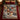 Nutcracker Snowy Courtyard woven blanket spread on a bed with burgundy bedding