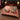 Opera Night Christmas Rose woven blanket with custom family name spread on a bed