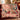 Opera Night Christmas Rose woven blanket with custom family name draped over a sofa, holiday room view