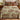 Otter Red-Osier Creek woven blanket spread across a bed in a cozy bedroom