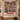 Personalized Patchwork Quilt Christmas photo blanket displayed on a wall above a bench