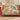 Peacock Dahlia Garden woven blanket draped over a sofa