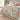 Peony Ribbon Garden woven blanket spread on a bed
