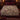 Blackberry Hedgehog Hollow botanical woven blanket spread across a bed