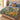Blue Stars and Honey botanical woven blanket spread across a bed