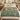 Bluebell Beechwood botanical woven blanket spread across a bed
