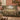 Blush Sage Meadow Glade woven blanket draped over a sofa or armchair