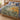 Borage and Calendula Rhythm botanical woven blanket spread across a bed