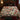 Cardinal Winterberry Holly Thicket Luxe botanical woven blanket spread across a bed
