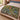 Coral Vine Passage botanical woven blanket spread across a bed