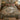 Cream Sage Stream botanical woven blanket spread across a bed