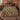 Cyclamen Rootwood botanical woven blanket spread across a bed
