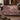 Cyclamen Rootwood woven blanket draped over a sofa or armchair