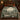 Fountain Stag Courtyard botanical woven blanket spread across a bed