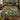 Frog Lily Pool botanical woven blanket spread across a bed