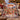 Rhinestone-style snowy village Christmas fleece throw with custom name draped over a cream sofa