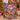 Woman holding a personalized Grinchmas village overlook fleece blanket with custom name in a Christmas living room