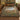 Hare Meadow botanical woven blanket spread across a bed