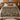 Medlar Hedgerow botanical woven blanket spread across a bed