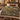 Medlar Hedgerow botanical woven blanket spread across a bed