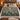 Mistletoe Poplars botanical woven blanket spread across a bed